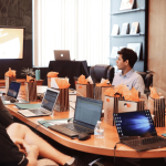 A team in an office discussing resource management during a meeting