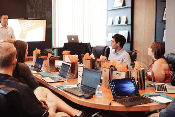 A team in an office discussing resource management during a meeting